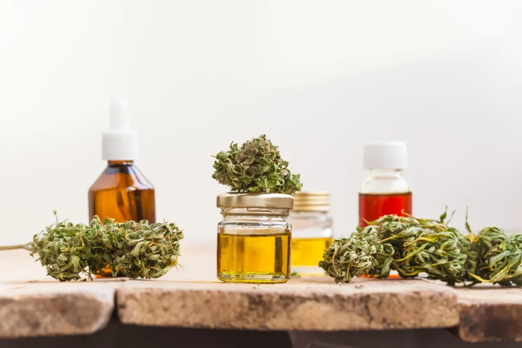 Bottles of oil, jars, and dried cannabis buds
